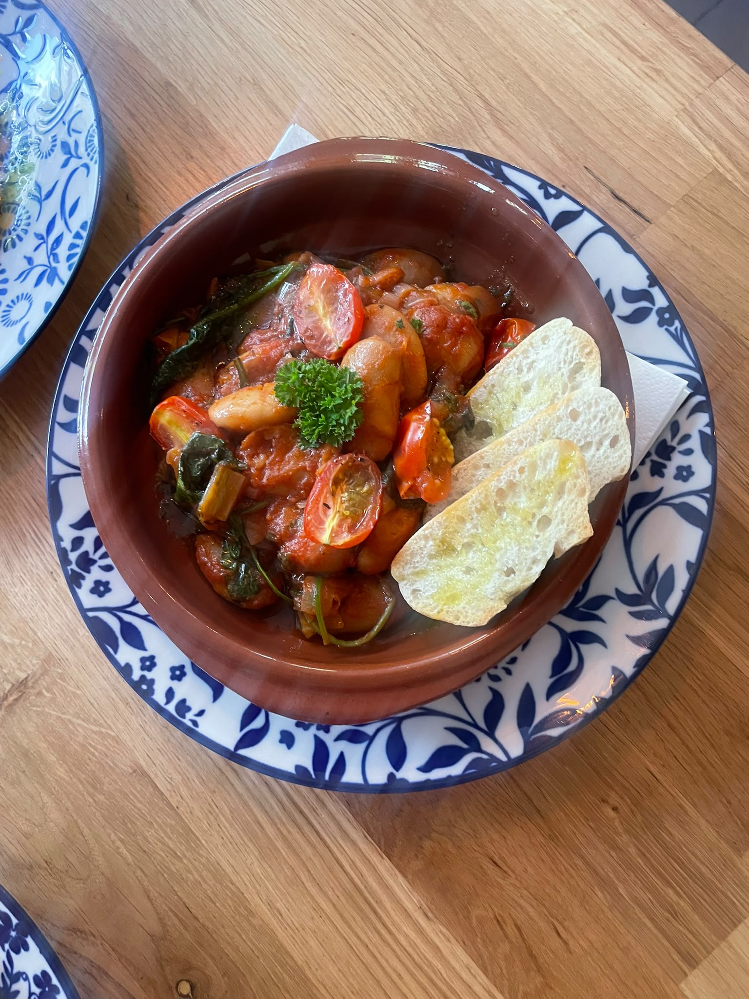 Restaurant dish served in a clay bowl at Soleá